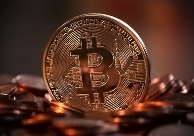 A closeup image of a coin with the bitcoin symbol on it