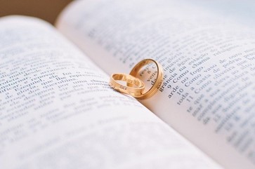 Weddings rings resting on a book