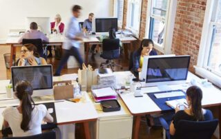 Employees work at their desks in a bright and modern office