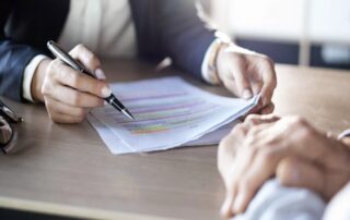 A businessman signs a settlement agreement