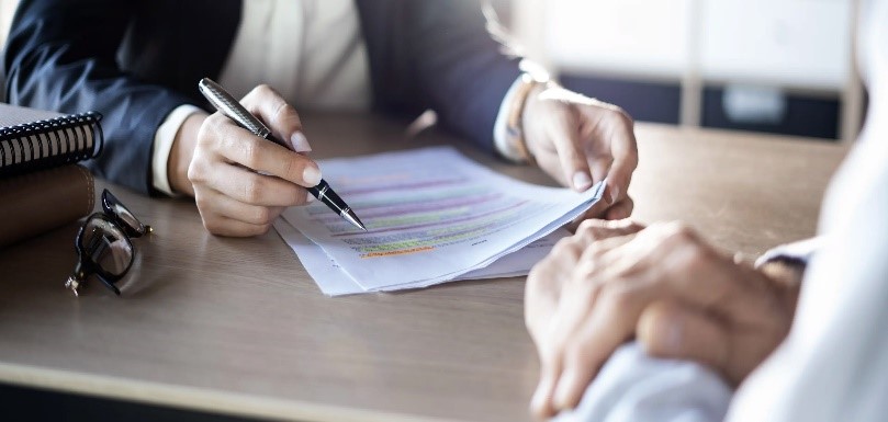 A businessman signs a settlement agreement