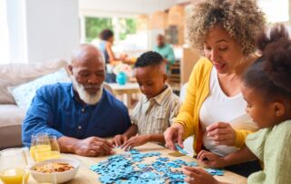 grandparents doing a jigsaw with their grandchildren