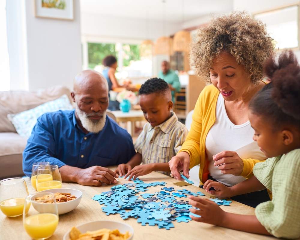 grandparents doing a jigsaw with their grandchildren