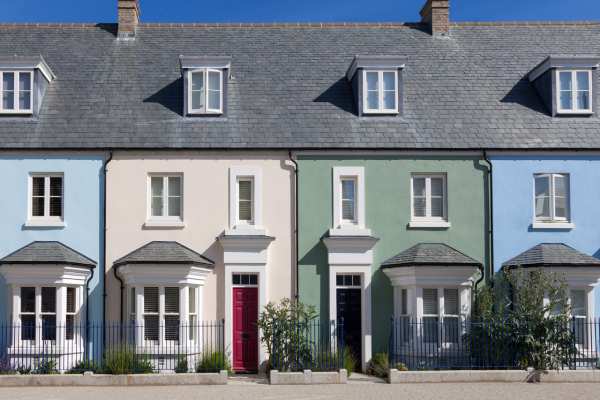 A row of colourful British terraced houses, pictured on a sunny day