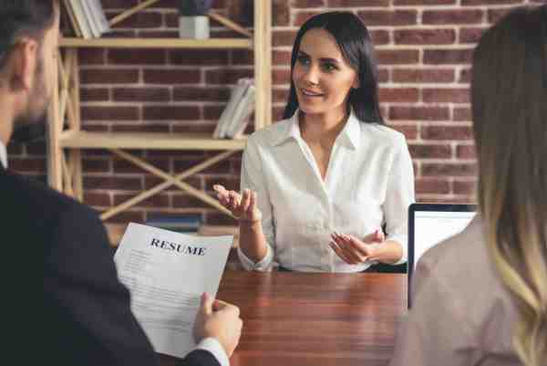 A young woman is interviewed by an employer