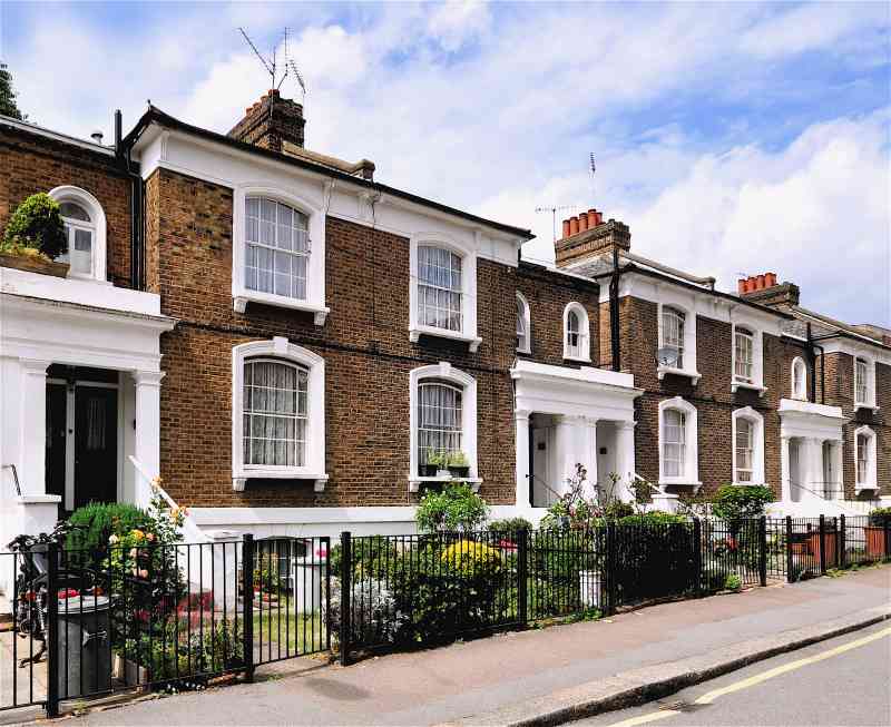 A row of traditional brick houses in Britain, pictured on a sunny day