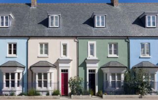 A row of colourful British terraced houses, pictured on a sunny day