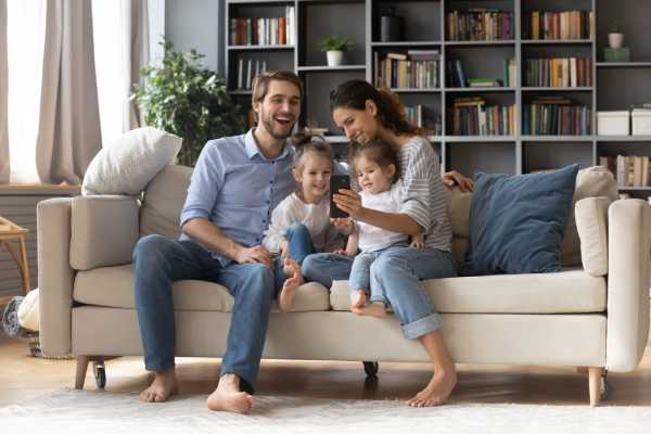 A young family relax on the couch