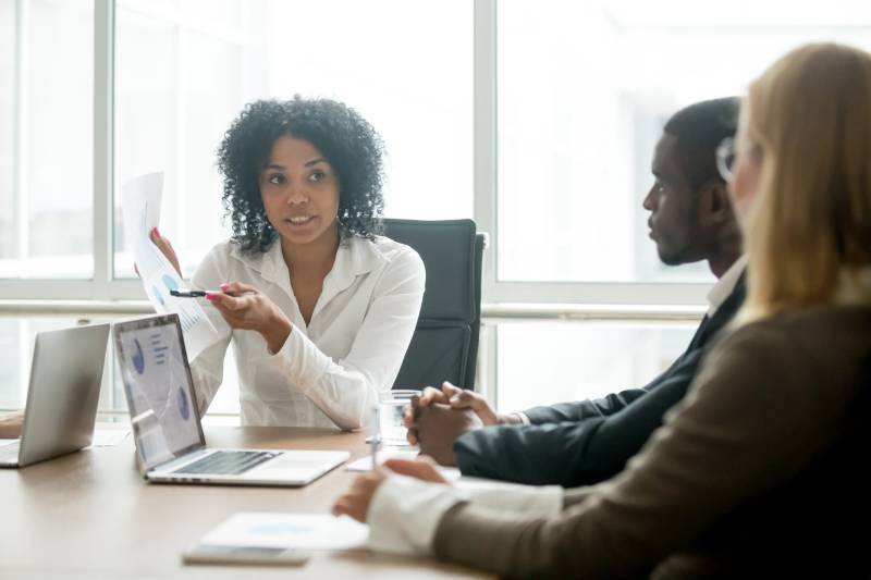 A businessman and a businesswoman consult with a commercial litigation solicitor