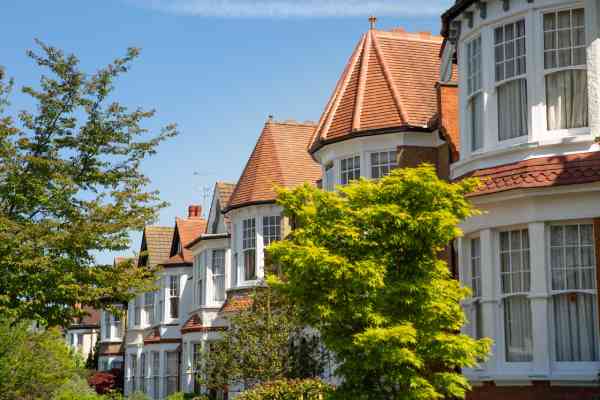 A row of traditional terraced houses, pictured on a sunny day