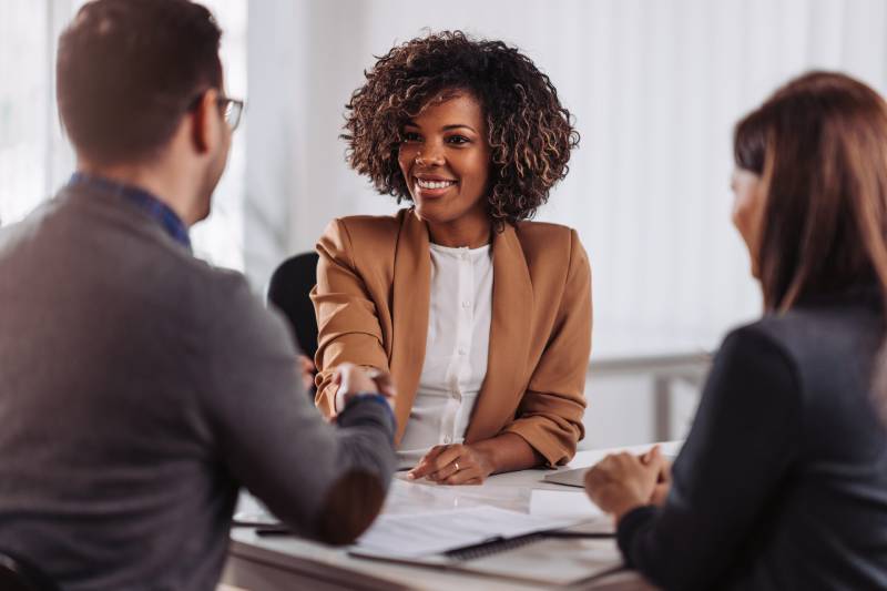 A solicitor shakes the hand of her client during an inheritance tax planning consultation