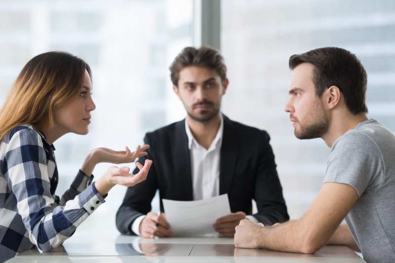 A separated couple argue while they consult with a solicitor about separation agreements